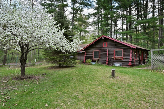 9262 Park Ave, Solon Springs, WI 54873 - view of property exterior with log siding and a lawn
