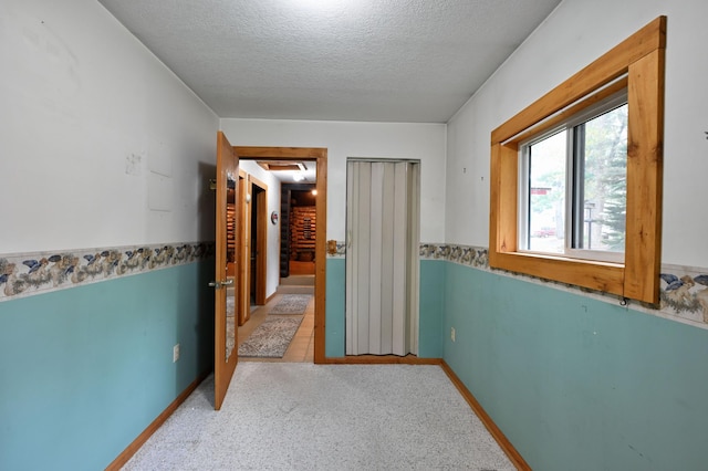 9262 Park Ave, Solon Springs, WI 54873 - corridor with a textured ceiling and light carpet