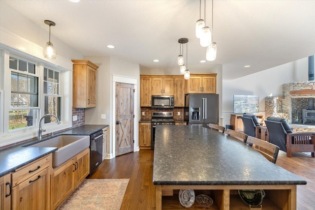 701 Chalupsky Ave SE, New Prague, MN 56071 - kitchen with appliances with stainless steel finishes, a sink, dark countertops, open shelves, and dark wood-style flooring