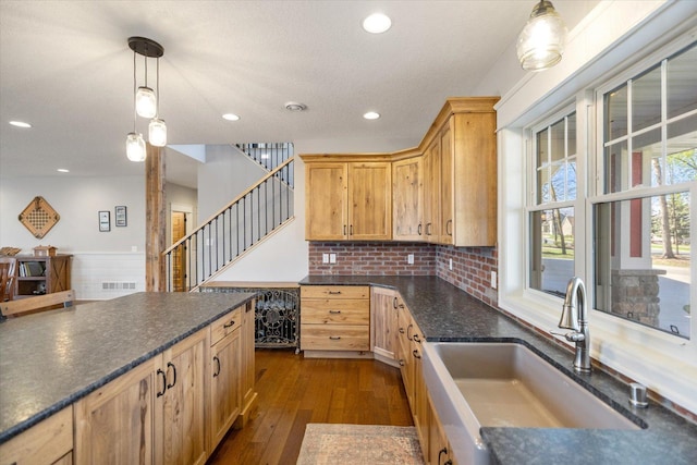 701 Chalupsky Ave SE, New Prague, MN 56071 - kitchen with a sink, recessed lighting, hanging light fixtures, a wainscoted wall, and dark wood-style flooring