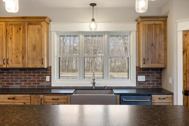 701 Chalupsky Ave SE, New Prague, MN 56071 - kitchen featuring a sink, hanging light fixtures, dishwashing machine, and backsplash