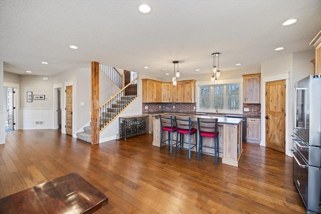 701 Chalupsky Ave SE, New Prague, MN 56071 - kitchen with high end fridge, a center island, dark wood-type flooring, a sink, and recessed lighting