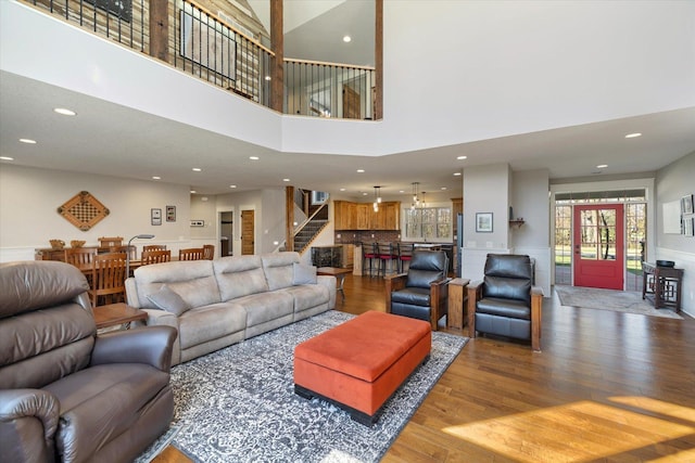 701 Chalupsky Ave SE, New Prague, MN 56071 - living area featuring wood finished floors, recessed lighting, stairway, and wainscoting