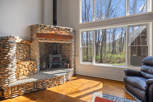 701 Chalupsky Ave SE, New Prague, MN 56071 - living area with a wood stove, hardwood / wood-style floors, and a towering ceiling