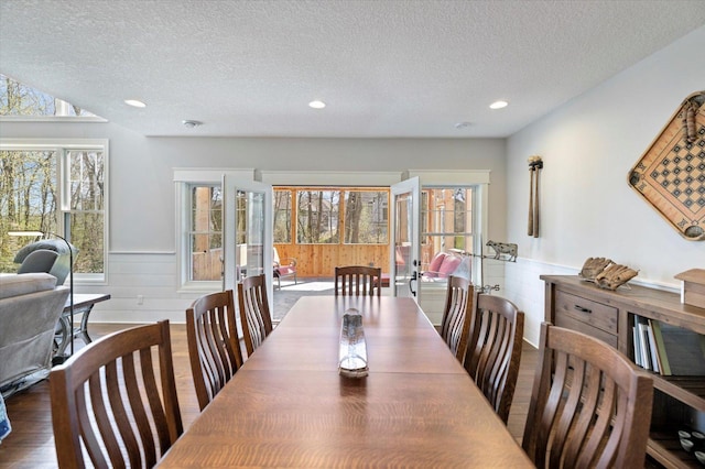 701 Chalupsky Ave SE, New Prague, MN 56071 - dining space with wainscoting, wood finished floors, a textured ceiling, healthy amount of natural light, and recessed lighting