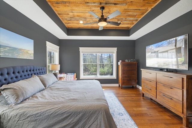 701 Chalupsky Ave SE, New Prague, MN 56071 - bedroom featuring a tray ceiling, wood ceiling, baseboards, dark wood-style floors, and ceiling fan