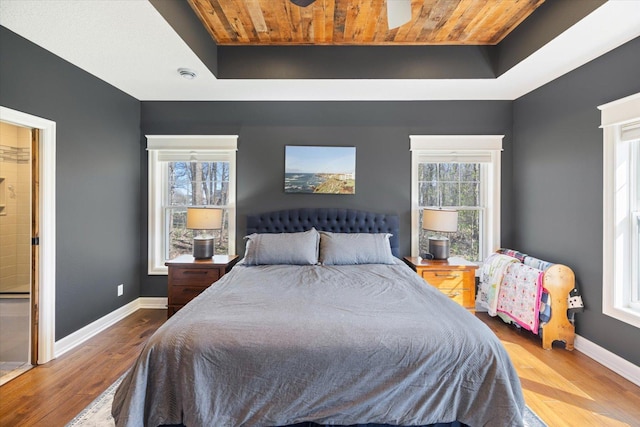 701 Chalupsky Ave SE, New Prague, MN 56071 - bedroom with a raised ceiling, wood finished floors, wood ceiling, and baseboards