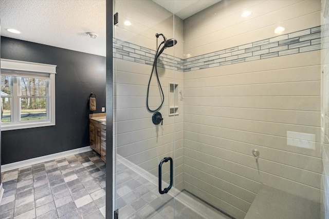 701 Chalupsky Ave SE, New Prague, MN 56071 - bathroom featuring a stall shower, baseboards, recessed lighting, and vanity