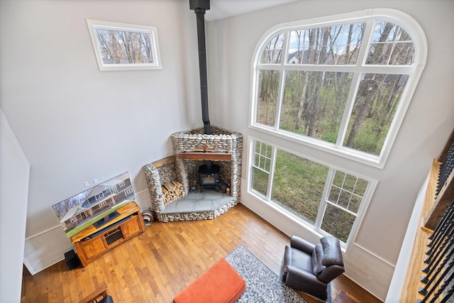 701 Chalupsky Ave SE, New Prague, MN 56071 - unfurnished living room with a wood stove, healthy amount of natural light, and wood finished floors