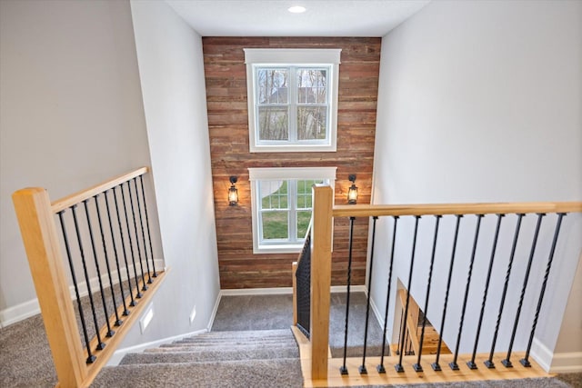 701 Chalupsky Ave SE, New Prague, MN 56071 - staircase with wooden walls, baseboards, and carpet flooring