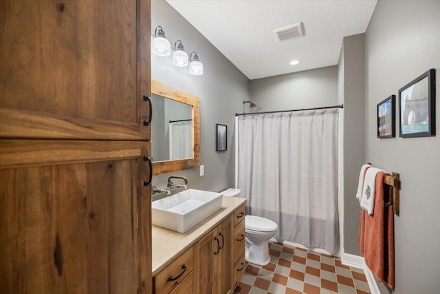 701 Chalupsky Ave SE, New Prague, MN 56071 - full bathroom featuring vanity, tile patterned floors, toilet, and shower / tub combo with curtain
