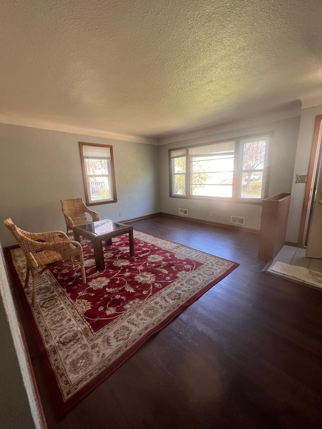 1008 4th St E, Saint Paul, MN 55106 - living area with a textured ceiling, wood finished floors, and baseboards