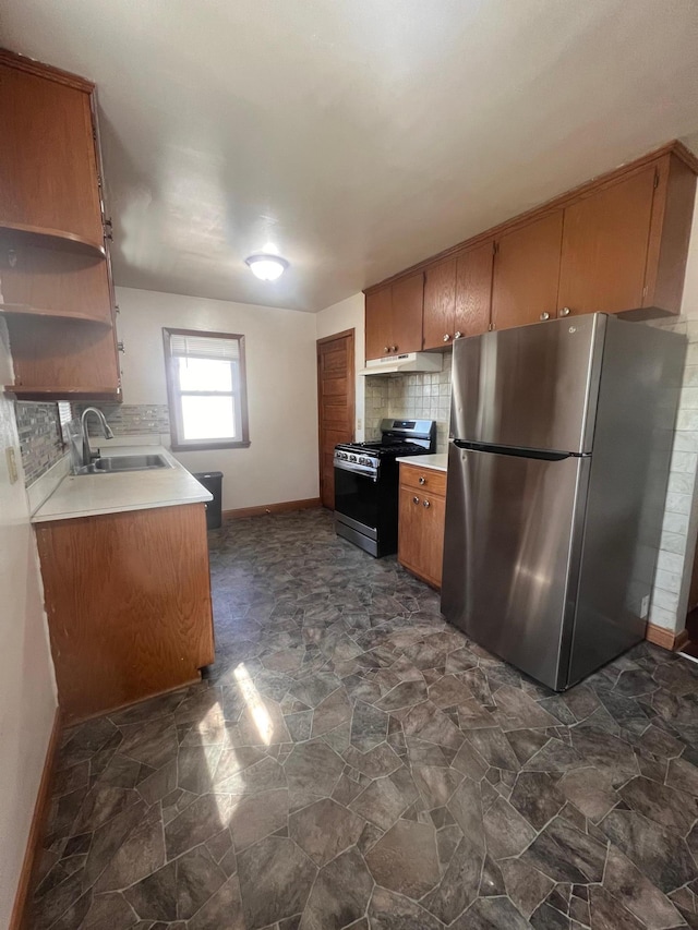 1008 4th St E, Saint Paul, MN 55106 - kitchen featuring appliances with stainless steel finishes, baseboards, stone finish floors, a sink, and backsplash