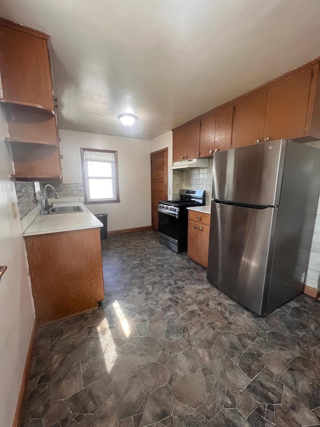 1008 4th St E, Saint Paul, MN 55106 - kitchen featuring appliances with stainless steel finishes, a sink, under cabinet range hood, baseboards, and tasteful backsplash