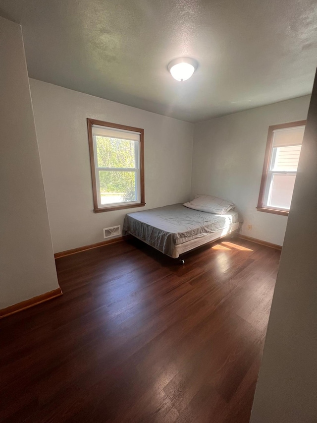 1008 4th St E, Saint Paul, MN 55106 - bedroom featuring multiple windows, wood finished floors, and baseboards