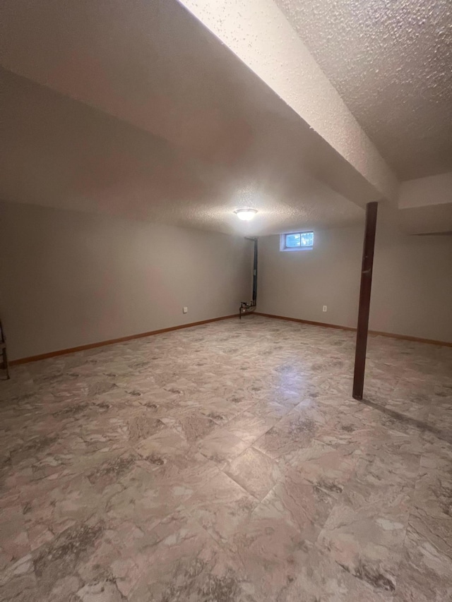1008 4th St E, Saint Paul, MN 55106 - basement with a textured ceiling and baseboards