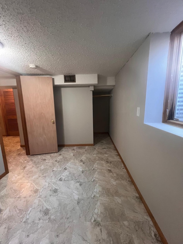 1008 4th St E, Saint Paul, MN 55106 - bonus room with a textured ceiling and baseboards