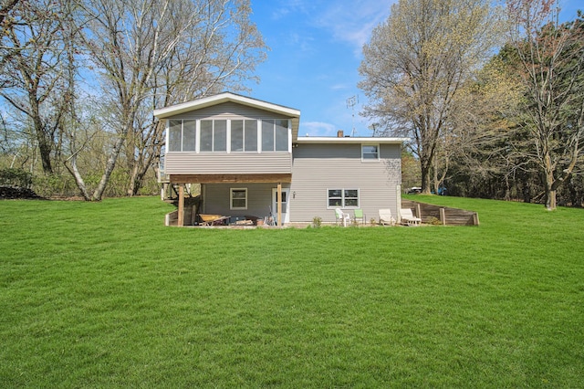1418 345th Ave, Frederic, WI 54837 - back of house with a sunroom, a lawn, and a patio area