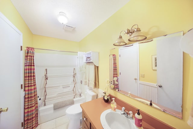 1418 345th Ave, Frederic, WI 54837 - bathroom with vanity, toilet, shower / bath combo, tile patterned floors, and a textured ceiling