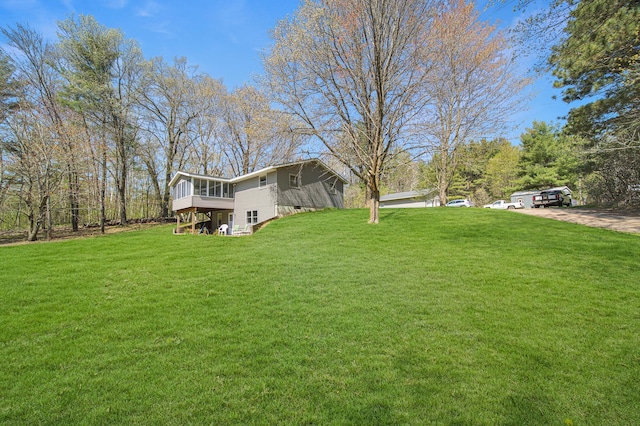 1418 345th Ave, Frederic, WI 54837 - view of green lawn featuring a sunroom, a deck, and driveway