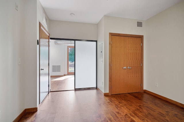 unfurnished bedroom with wood finished floors and baseboards