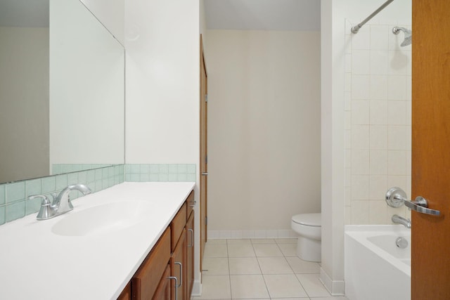 full bathroom featuring toilet, tile patterned flooring, baseboards, vanity, and bathtub / shower combination