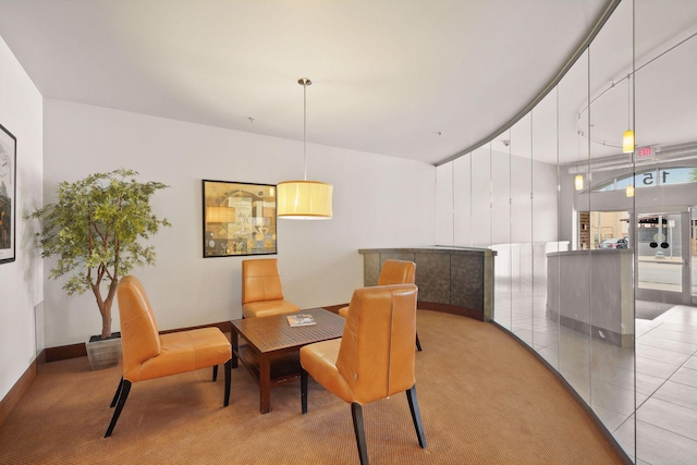 carpeted dining space with baseboards