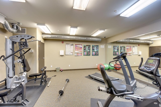 exercise room featuring baseboards
