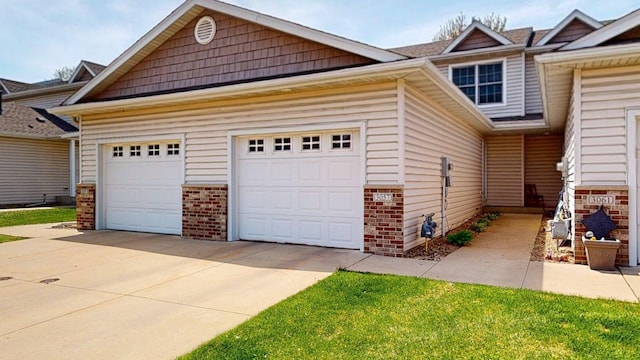 view of front of home featuring brick siding, concrete driveway, and an attached garage