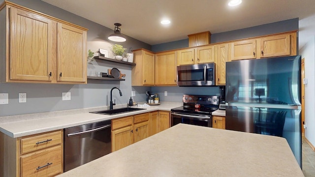 kitchen featuring appliances with stainless steel finishes, a sink, light brown cabinetry, light countertops, and recessed lighting
