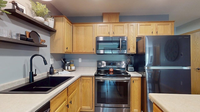 kitchen featuring appliances with stainless steel finishes, open shelves, a sink, light countertops, and light brown cabinetry