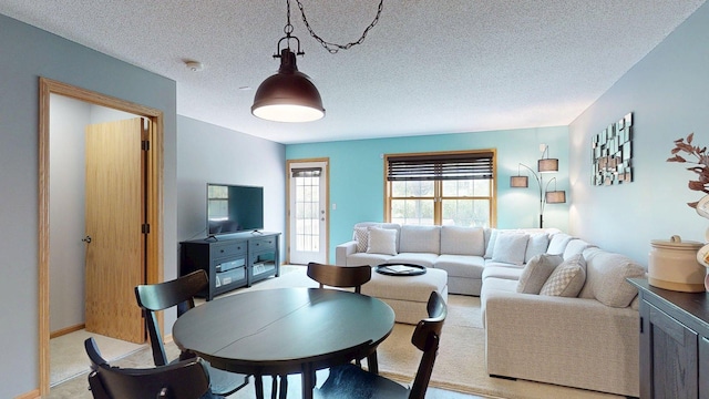 living area featuring light carpet and a textured ceiling