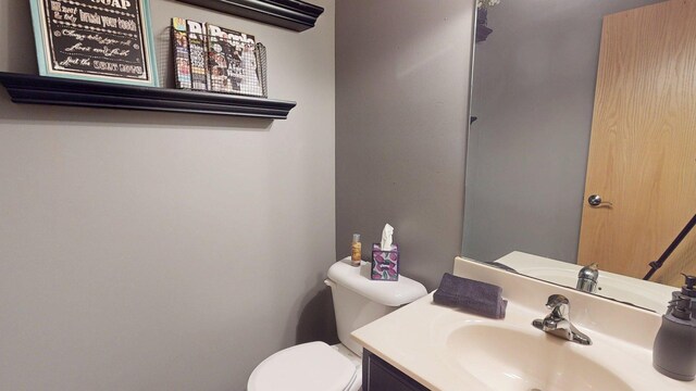 bathroom featuring toilet and vanity