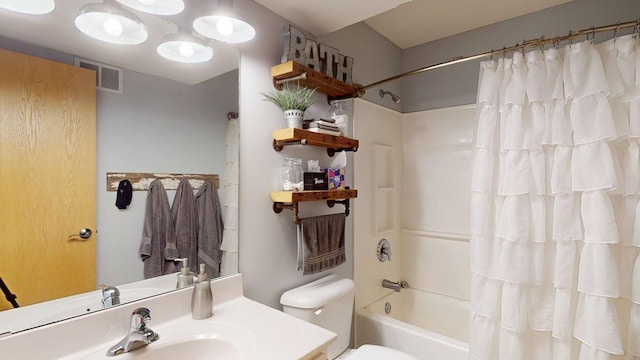 bathroom featuring toilet, shower / bath combo, and vanity