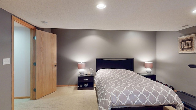 carpeted bedroom with baseboards, recessed lighting, and a textured ceiling