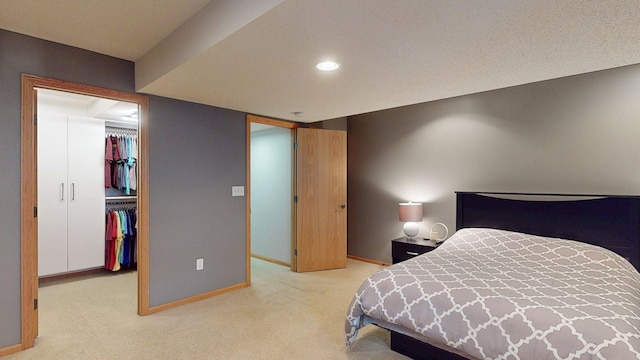 bedroom featuring baseboards, carpet flooring, a spacious closet, a closet, and recessed lighting