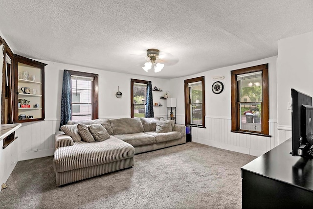 706 Broad St, Mankato, MN 56001 - living area featuring a wainscoted wall, a ceiling fan, a textured ceiling, and carpet