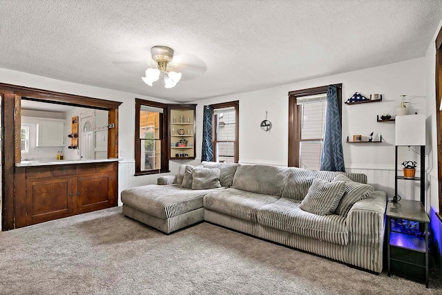 706 Broad St, Mankato, MN 56001 - living room featuring ceiling fan, a textured ceiling, wainscoting, and carpet floors