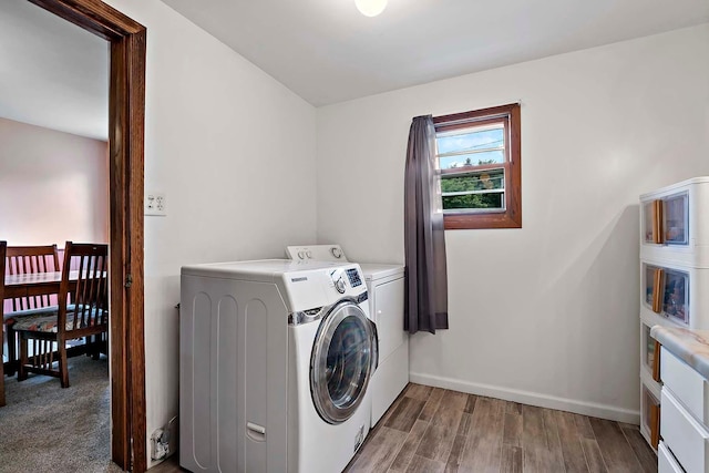 706 Broad St, Mankato, MN 56001 - laundry area featuring washing machine and dryer, baseboards, and light wood-style floors