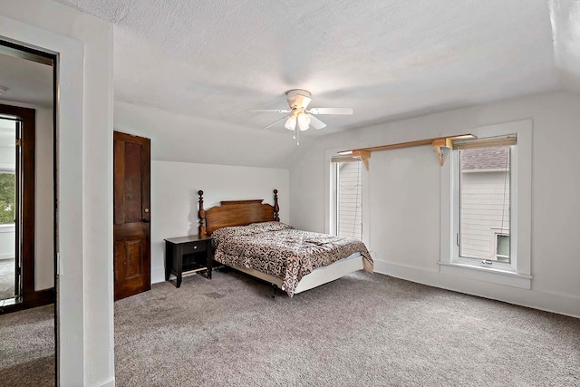 706 Broad St, Mankato, MN 56001 - carpeted bedroom featuring multiple windows, ceiling fan, a textured ceiling, lofted ceiling, and baseboards