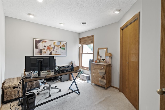 office with light carpet and a textured ceiling