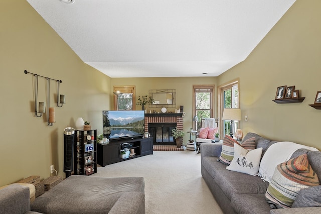 living room featuring carpet and a brick fireplace