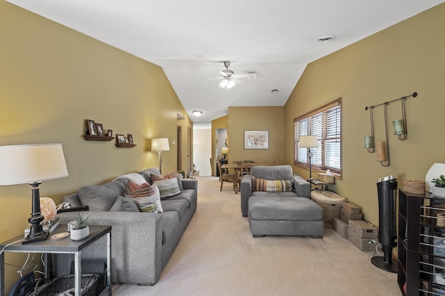 living area with light colored carpet, a ceiling fan, and lofted ceiling