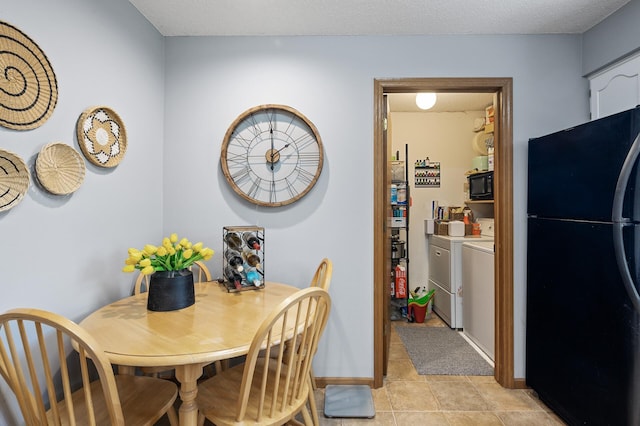 dining area with separate washer and dryer, light tile patterned floors, and baseboards