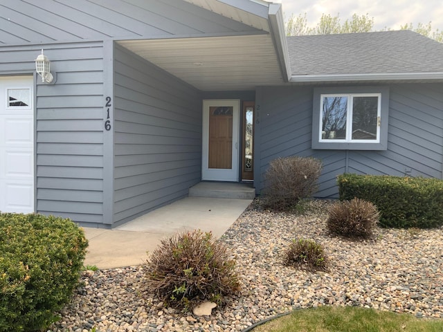 doorway to property featuring a garage