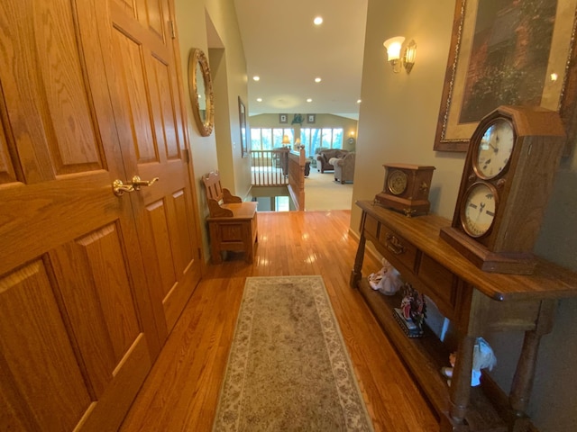 hallway with light wood-type flooring and recessed lighting