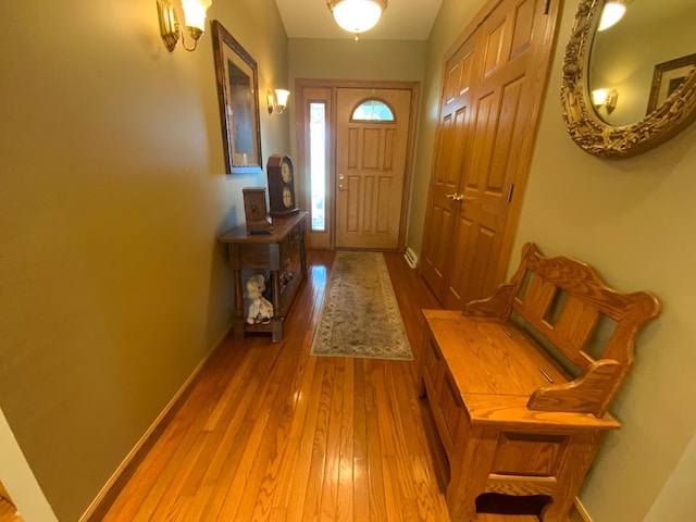 foyer entrance featuring wood finished floors and baseboards
