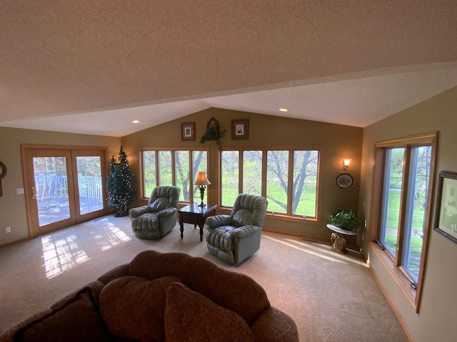 carpeted living area featuring vaulted ceiling, plenty of natural light, a textured ceiling, baseboards, and recessed lighting