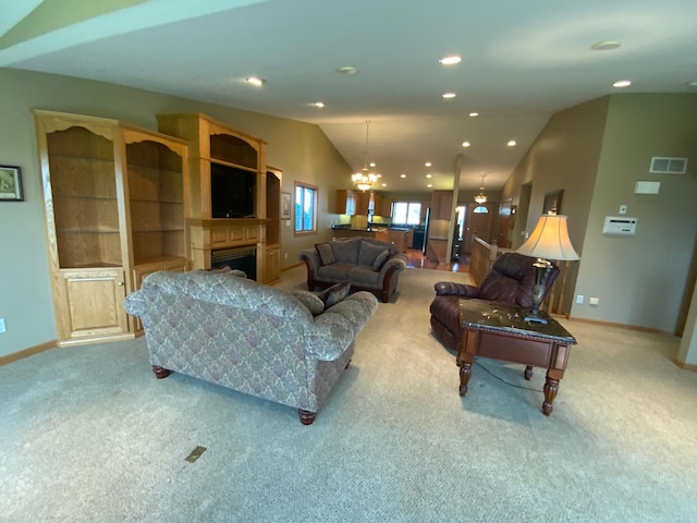 living area featuring light colored carpet, lofted ceiling, baseboards, a chandelier, and recessed lighting