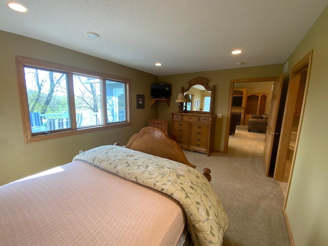 bedroom with light colored carpet and recessed lighting